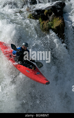 A kayaker drops a waterfall on the Deschutes River Stock Photo