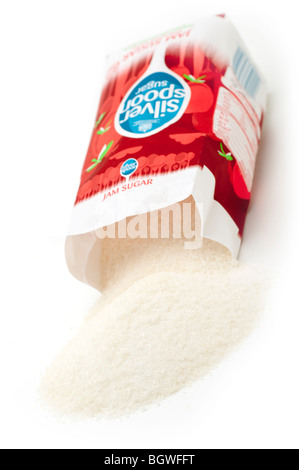 Bag of Jam sugar spilling onto a white surface Stock Photo