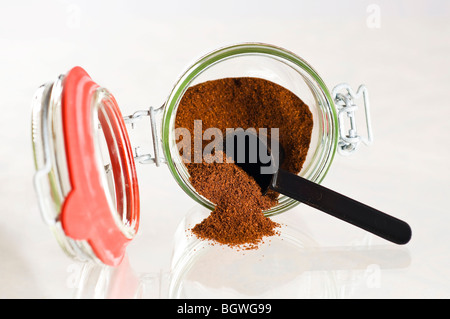 Storage jar with coffee on a light background Stock Photo