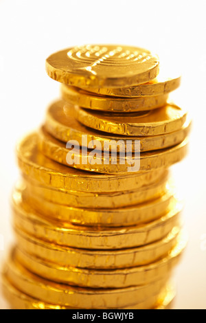 Pile of chocolate gold coins wrapped in foil close up Menora emblem embossed on top coin Stock Photo