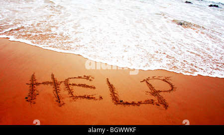 HELP in sand Stock Photo