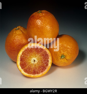 Whole and sectioned blood orange fruit variety Tarocco Stock Photo