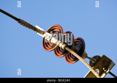 High voltage (33kV) ceramic insulators used to support and insulate a single overhead aluminum conductor. Stock Photo