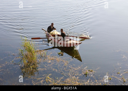 Two fishermen on their boat heading for shore on the River Nile in Middle Egypt Stock Photo