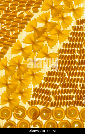 Abstract patterns and shapes of various pasta in backlit lighting Stock Photo