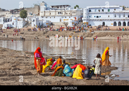 Pilgrims making offerings in the Lake during the Camel Festival in Pushkar India Stock Photo