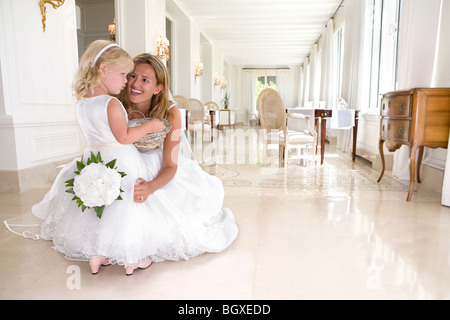 bride with young flower girl talk Stock Photo