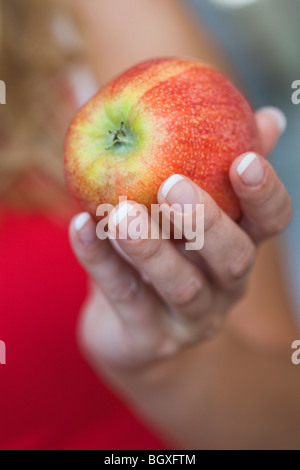 Young woman holding an apple Stock Photo