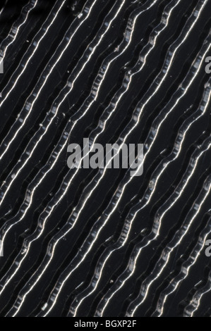 The grooves on a 45RPM stereo single vinyl record photographed at 25x resolution Stock Photo