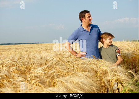 Father and son in a wheat field Stock Photo