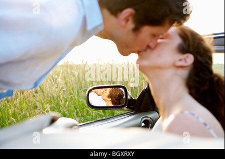 Couple kissing in a convertible Stock Photo