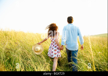 Couple holding hands in a wheat field Stock Photo