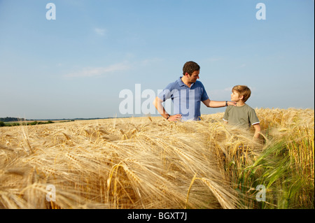 Father and son in a wheat field Stock Photo