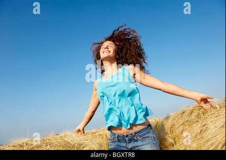 Woman walking in a wheat field Stock Photo
