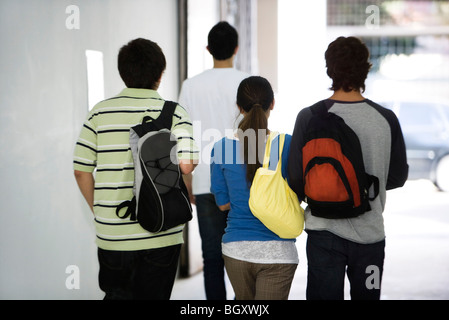 Students walking together in corridor, rear view Stock Photo