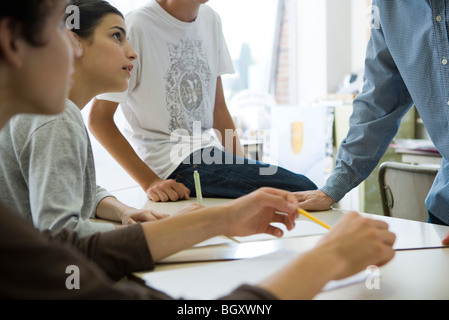 High school students, teacher in casual classroom conversation Stock Photo