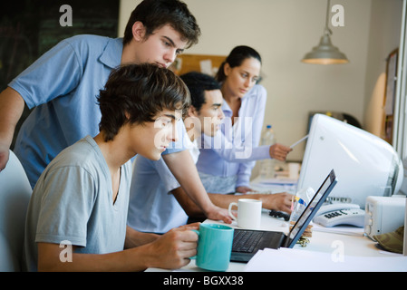 College students collaborating together using computers Stock Photo