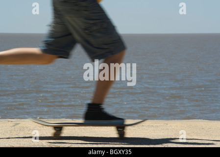 Skateboarding at seaside park Stock Photo