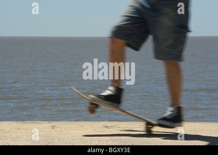 Skateboarding at seaside park Stock Photo