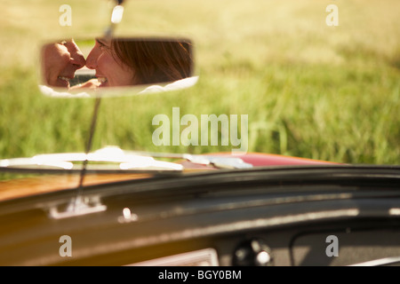 Couple in rear view mirror, will kiss Stock Photo