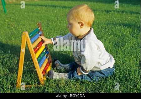 baby boy playing with an abacus Stock Photo