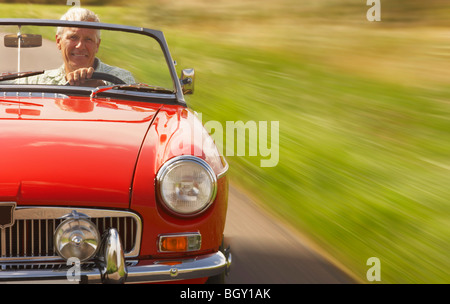 Senior man in sports car Stock Photo