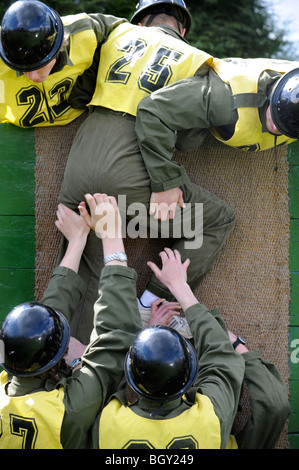 Sixteen year old boys tackle the wall during physical problem solving exercises at The Army Officer Selection Board in Westbury, Stock Photo