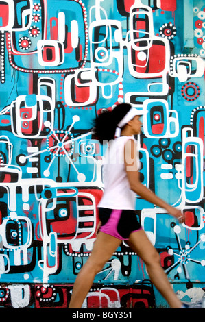 Woman passing a mural near Acland Street, St Kilda, Melbourne, Australia Stock Photo