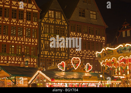 Lights from the market stalls and merry-go-round during the Christmas Markets at the Römerberg (City Hall Square) in the City of Stock Photo