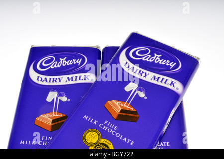 3 Cadbury chocolate candy bars in wrappers on white background. Stock Photo