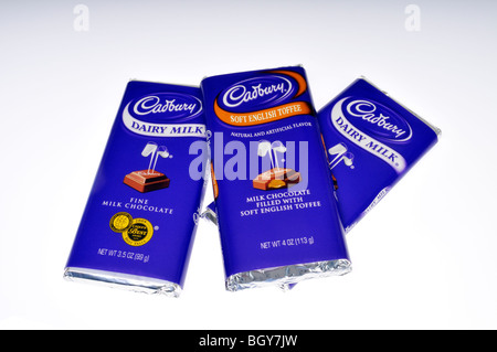 3 Cadbury chocolate candy bars in wrappers on white background. Stock Photo