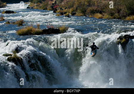 A kayaker drops a waterfall on the Deschutes River. Stock Photo