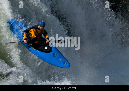 A kayaker drops a waterfall on the Deschutes River Stock Photo