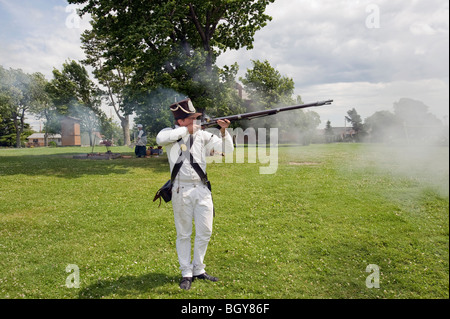 War of 1812 reenactor: American soldier firing musket. Stock Photo