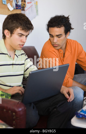 College studets collaborating with laptop computer Stock Photo