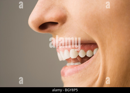 Woman laughing, side view Stock Photo