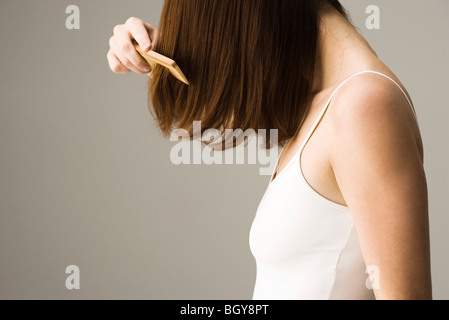 Woman combing hair Stock Photo