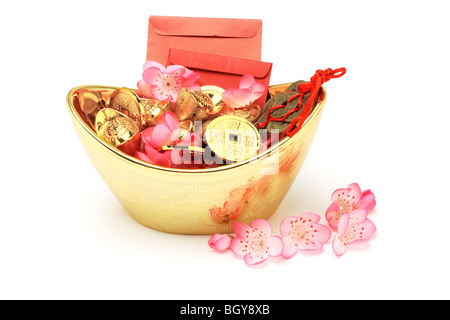 Chinese new year ornaments, red packets, gold ingots and coins on white background Stock Photo
