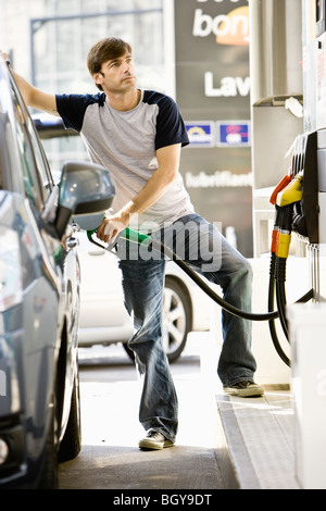 Man refueling vehicle at gas station Stock Photo