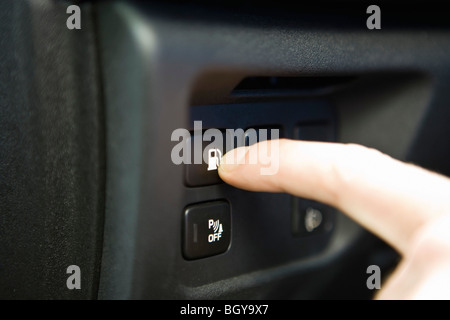 Pressing gas tank button on dashboard keypad Stock Photo