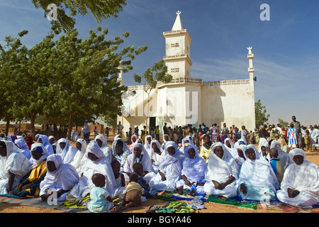 Women sitting in front of a mosque in the morning of Feast of Sacrifice, Ouagadougou, Burkina Faso. Stock Photo