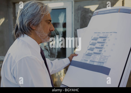 Architect reviewing blueprint Stock Photo
