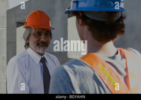 Construction supervisor talking with construction worker Stock Photo