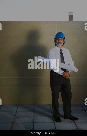 Architect carrying blueprint under arm, full length portrait Stock Photo