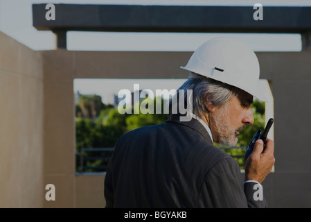 Construction supervisor communicating over walkie-talkie Stock Photo