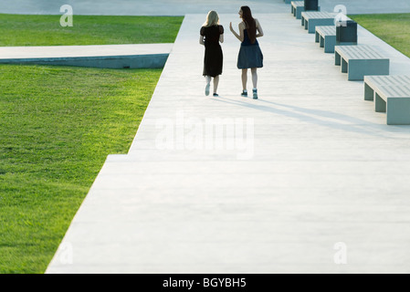 Friends walking together in conversation Stock Photo