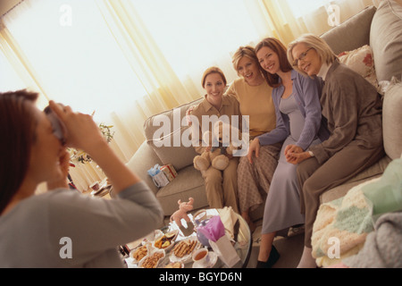 Woman taking picture at baby shower Stock Photo