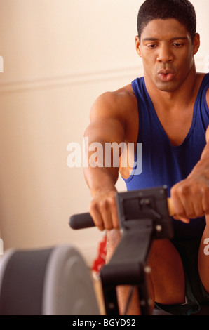 Man on exercise machine Stock Photo