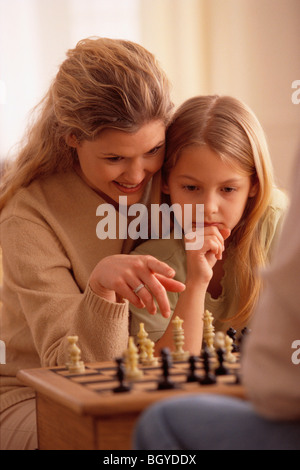 Mother and daugther playing chess Stock Photo