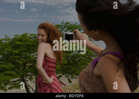 Young woman being photographed by friend Stock Photo